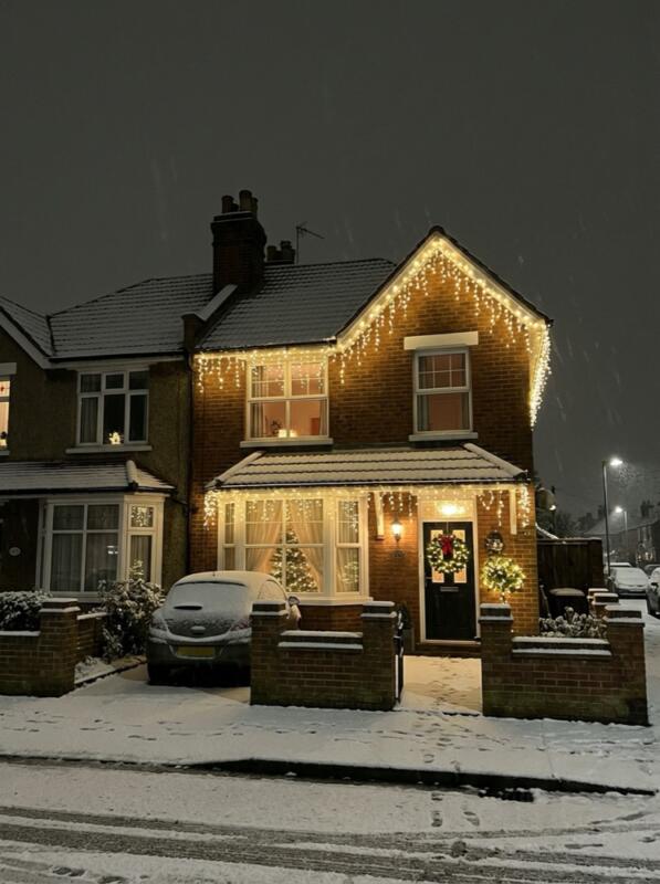 Icicle Lights Along the Roofline – Christmas front garden idea for UK homes