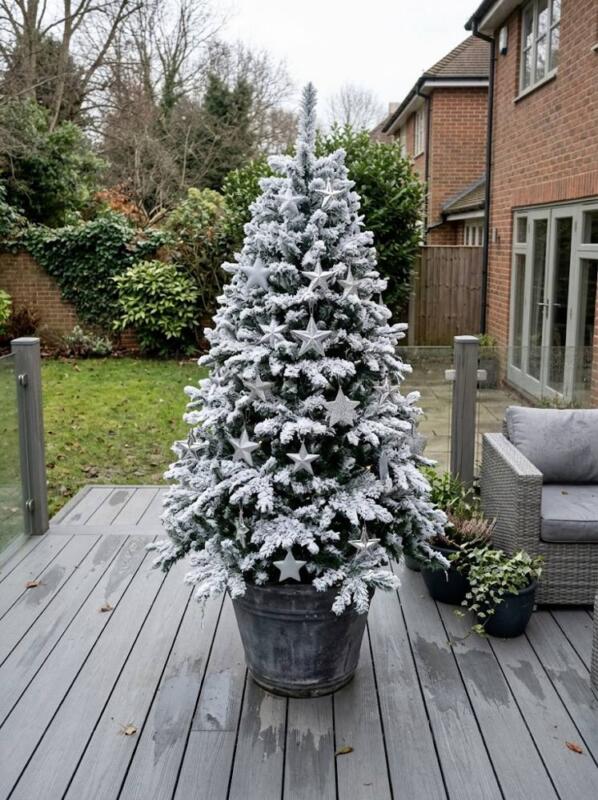 A Frosted Artificial Tree on Decking – outdoor Christmas tree idea for UK gardens and porches