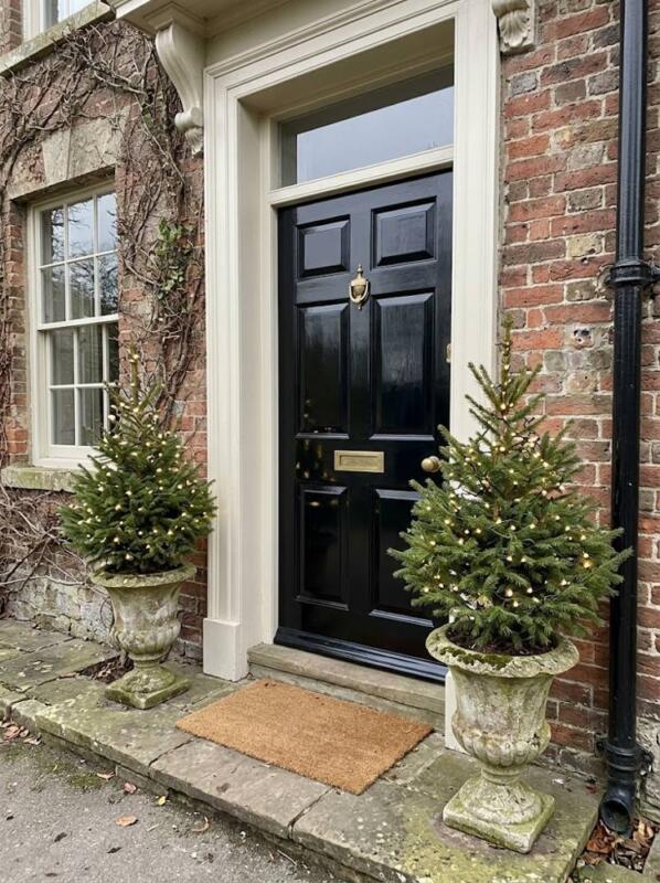 A Pair of Spruces in Stone Urns – outdoor Christmas tree idea for UK gardens and porches