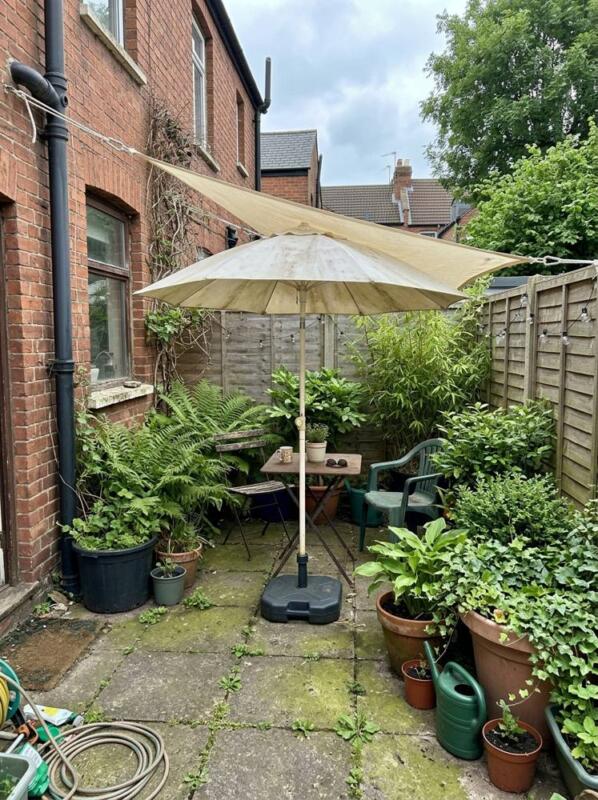 A Parasol and Big Potted Plants – budget patio idea for UK gardens